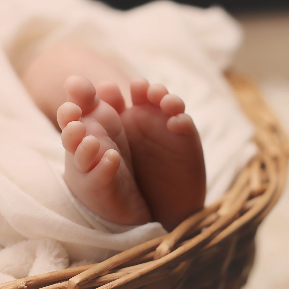 baby-s-feet-on-brown-wicker-basket-161534